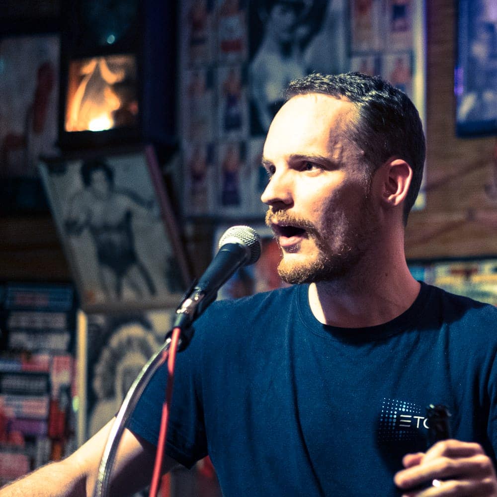 Graig Russell talks into a microphone.