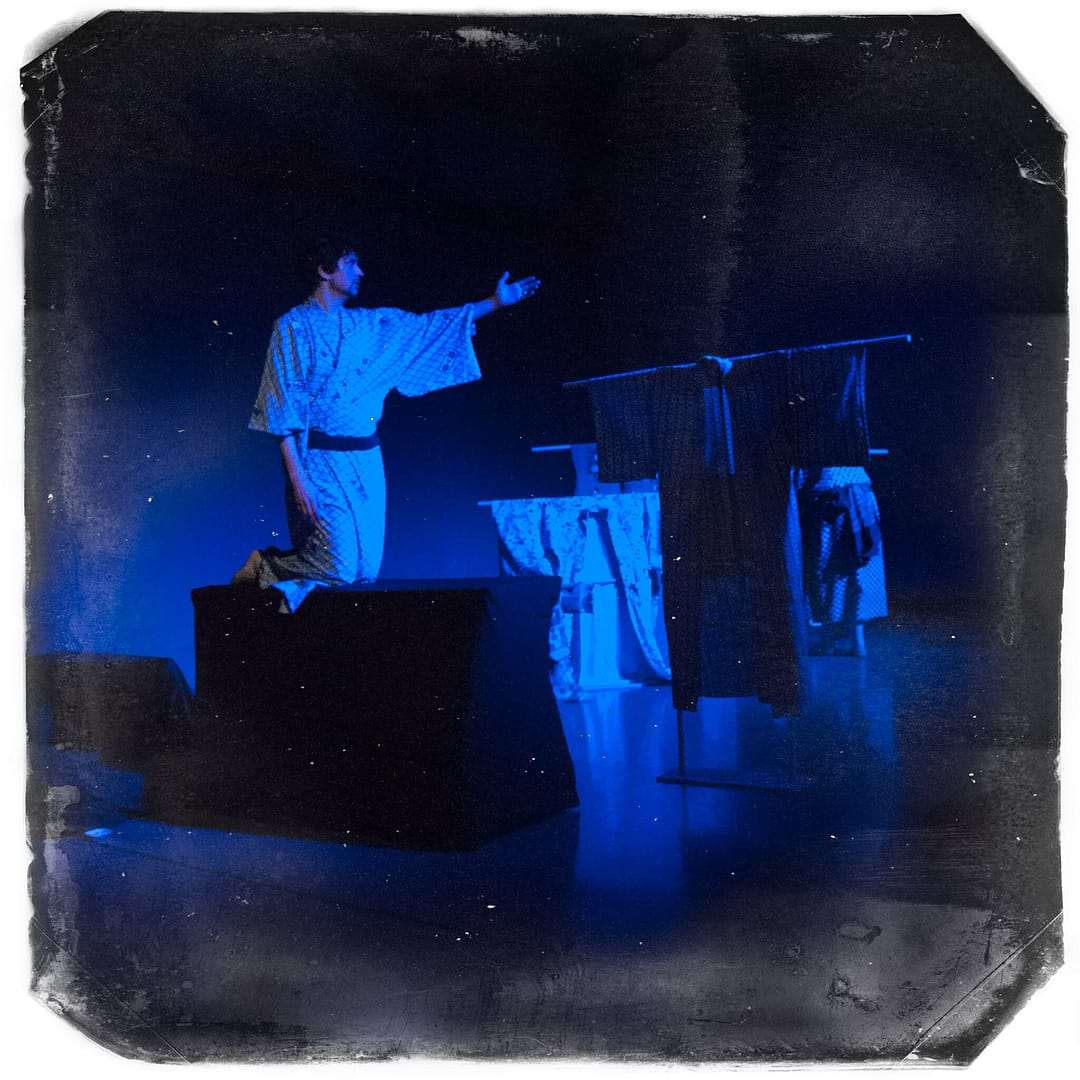 Naritsune (Andrew Woolner) rides the boat across the stage in Kikai-ga-shima.