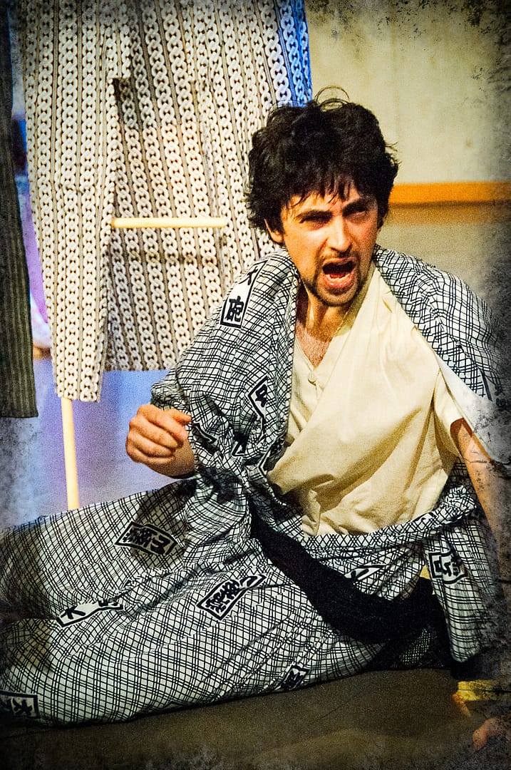 "Hey, ow!" says Andrew Woolner after being struck on the head.